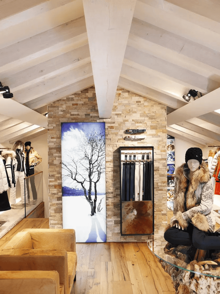Tree artwork displaying winter scene, modern retail interior for winter fashion.