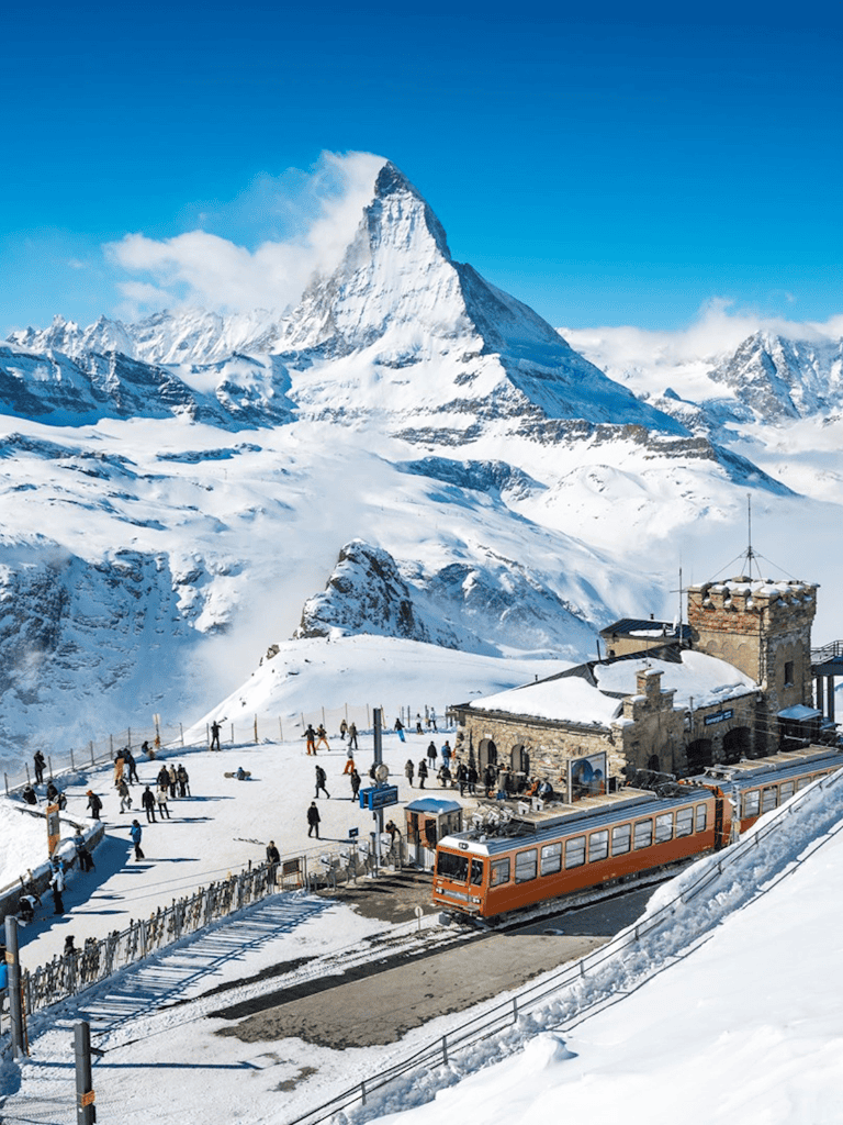 Snowy mountain landscape with Matterhorn peak and Glacier Paradise station, Zurich to Zermatt train tour.