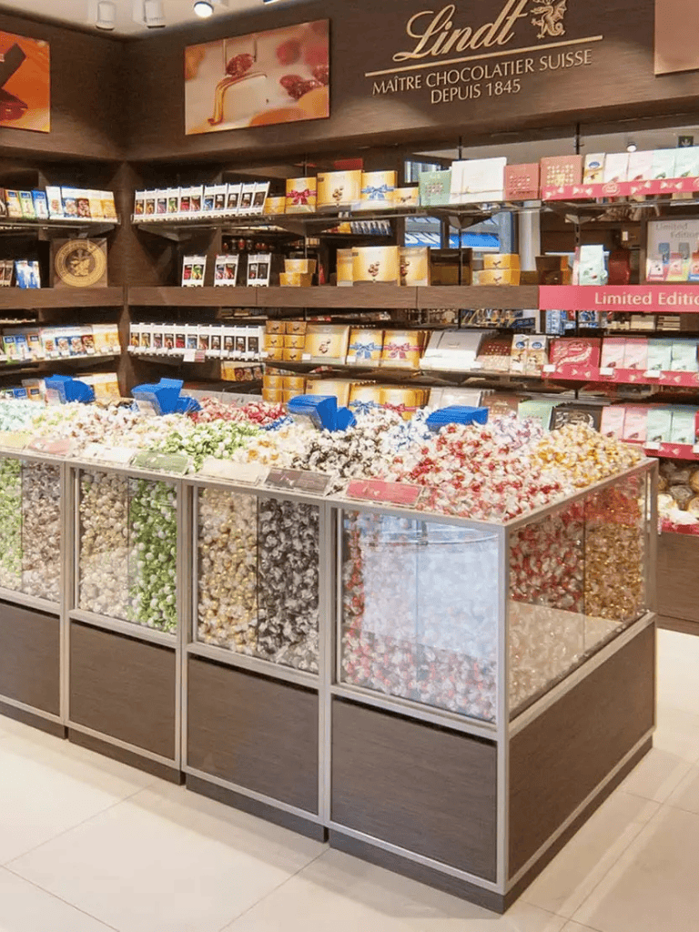 Assorted chocolates and candies display at a Lindt chocolate store, featuring various flavors and limited edition packaging.