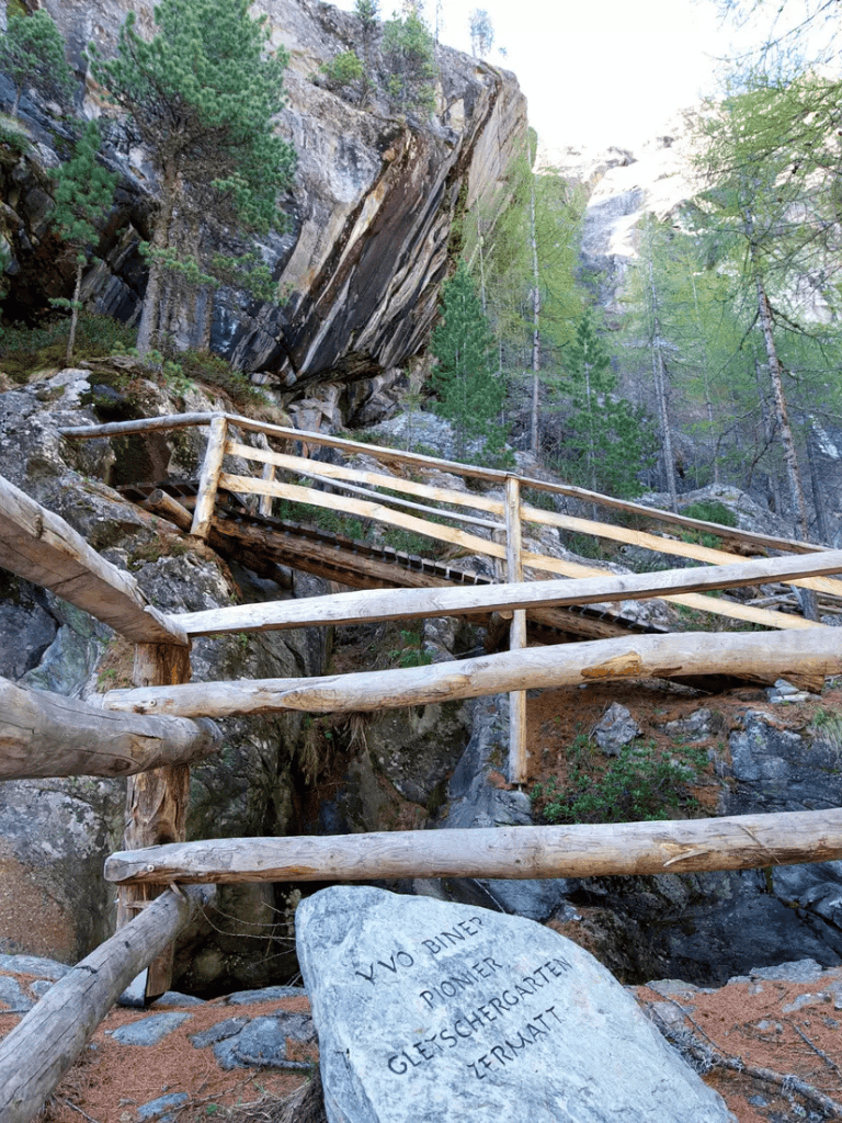 Secluded mountain trail with wooden railing and natural rock formations.