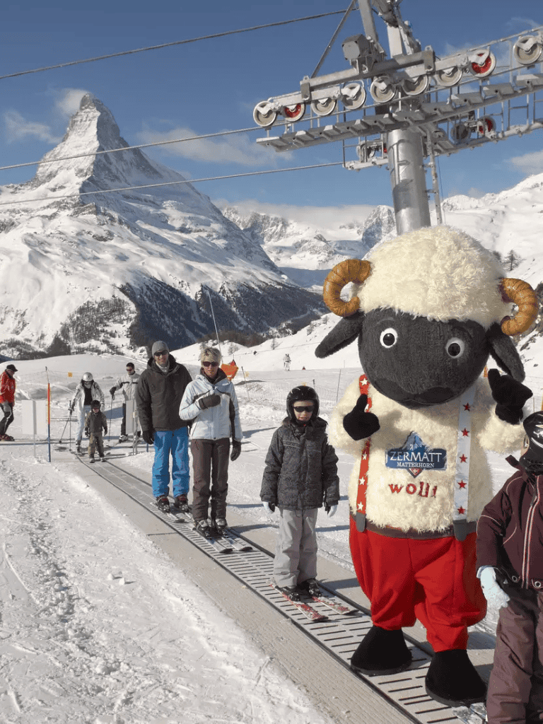 Ski resort with mascot and mountain scenery in Zermatt.