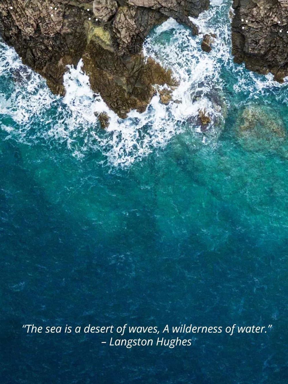 Vibrant ocean waves crashing against rugged coastal rocks, showcasing natural maritime beauty and adventure.