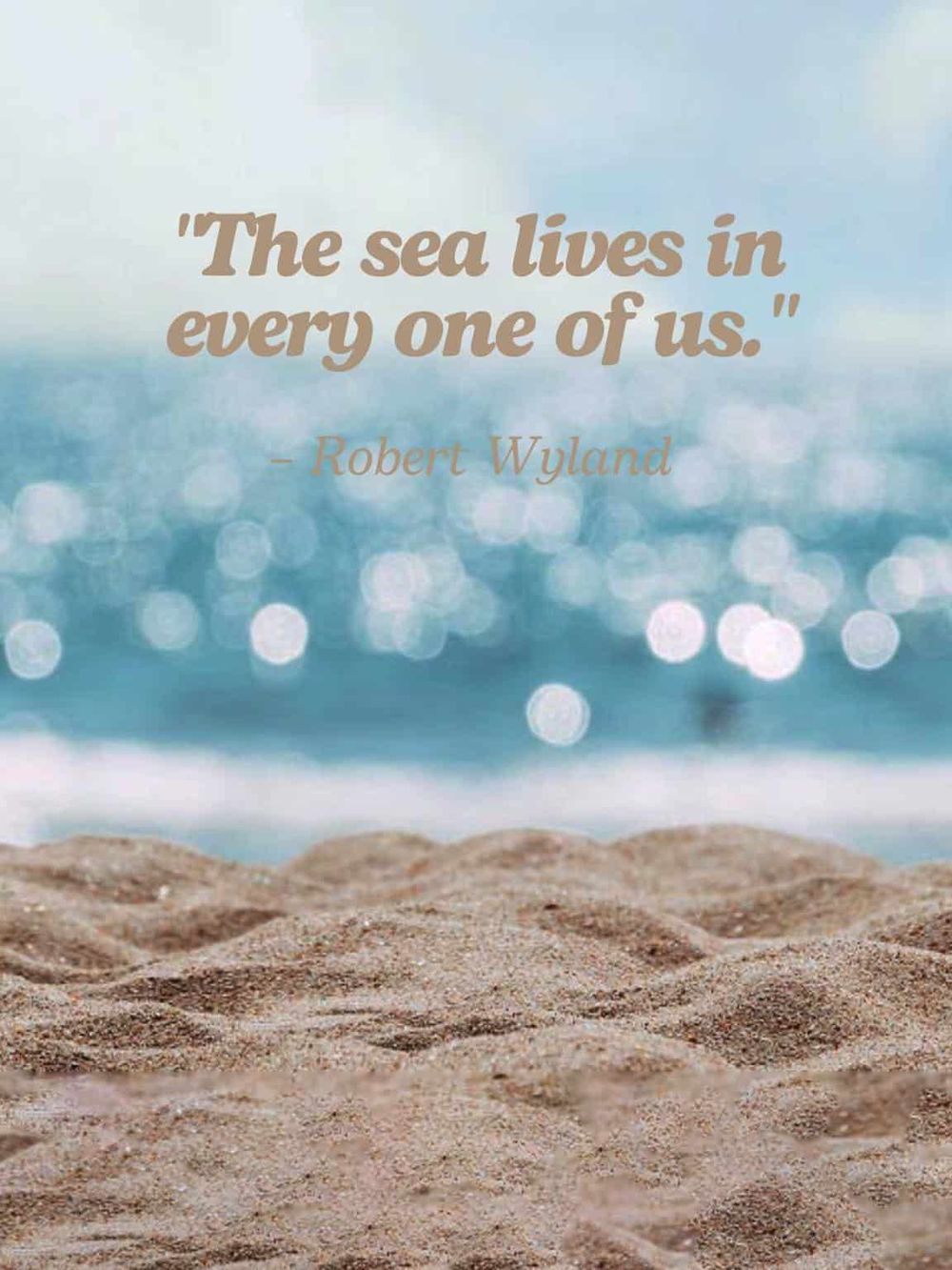 Seaside quote on sandy beach with ocean background, inspiring travel and adventure.