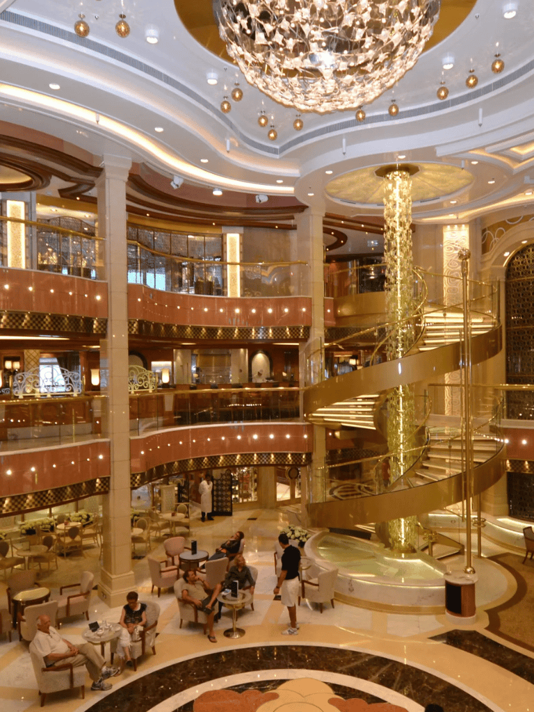Luxurious hotel lobby with grand staircase, elegant lighting, and modern decor for upscale travel experiences.