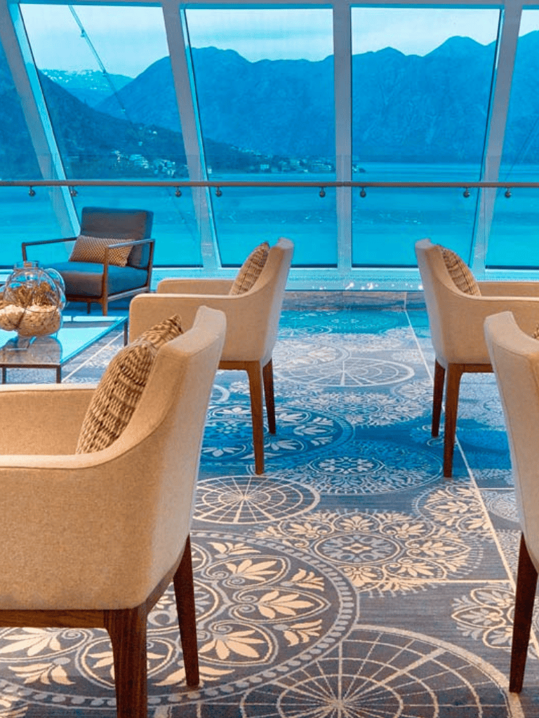 Cozy lakeside lounge with panoramic mountain views and elegant seating arrangements.