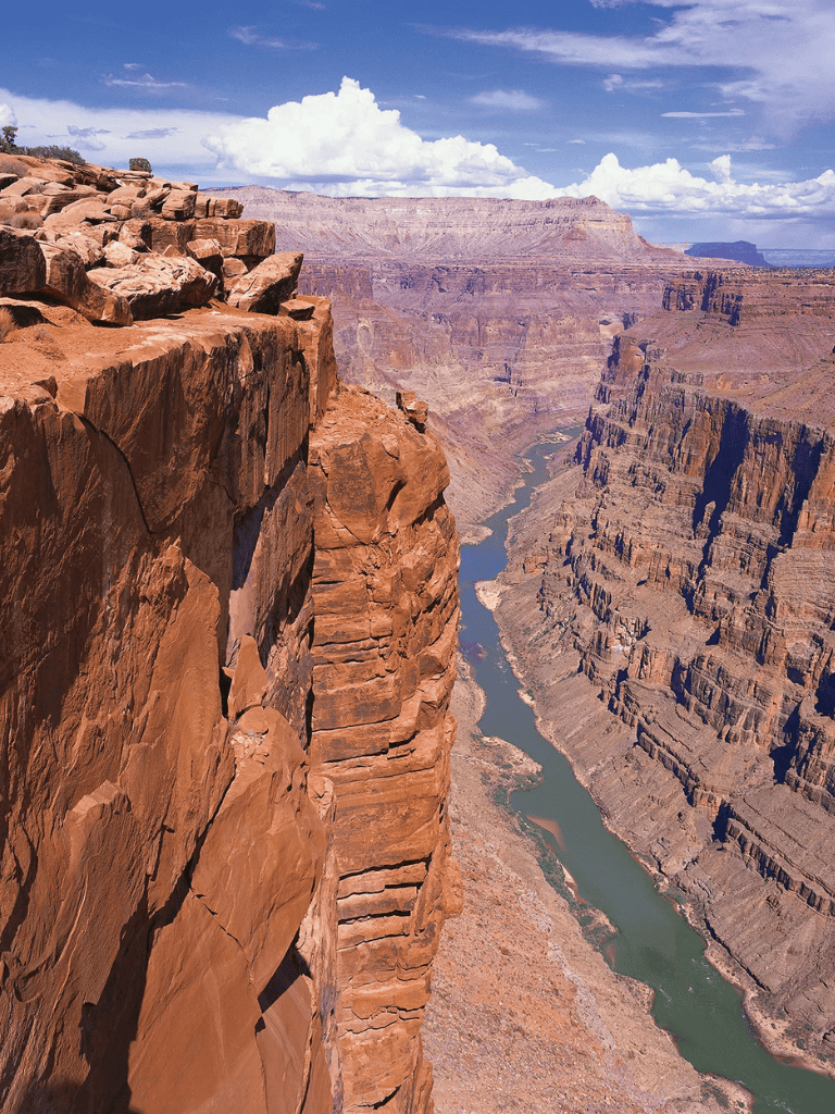 Breathtaking view of the Grand Canyon with rugged red cliffs and winding Colorado River.