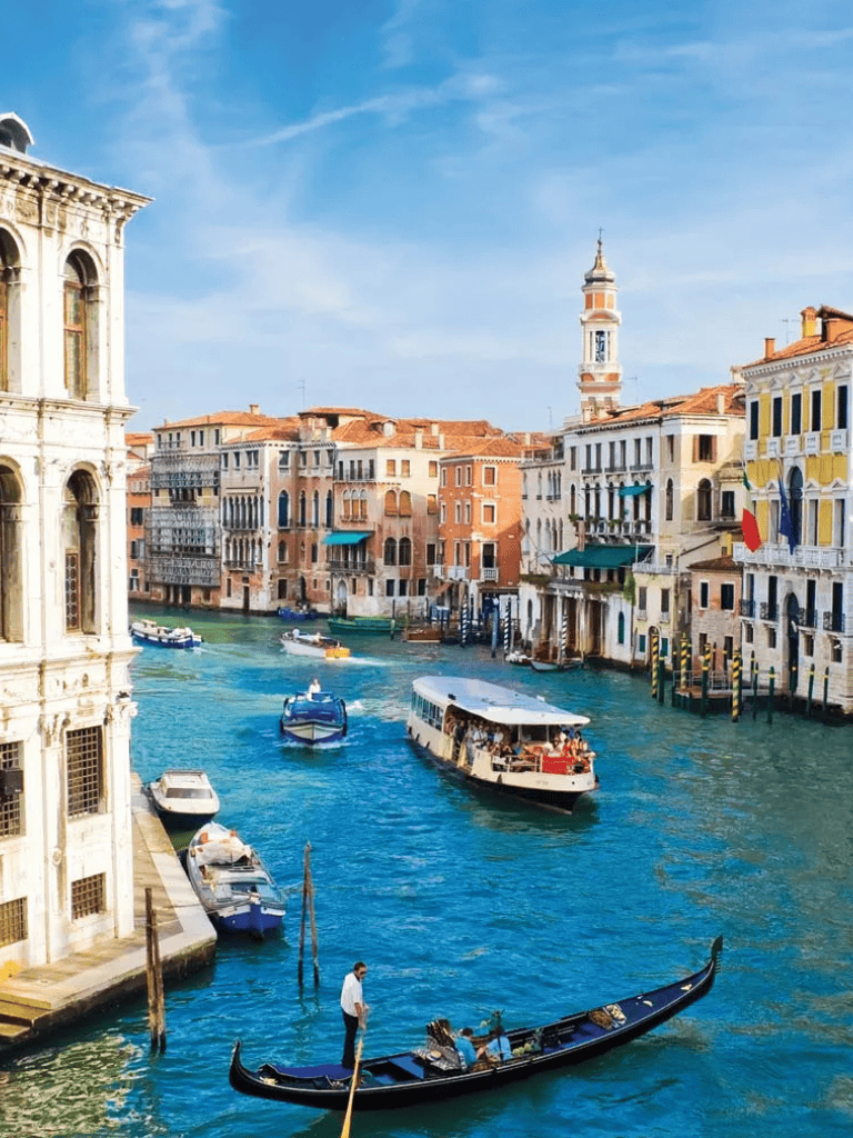 Vibrant Venice canal with boats and historic architecture, iconic Italian cityscape, travel, exploration, sightseeing.