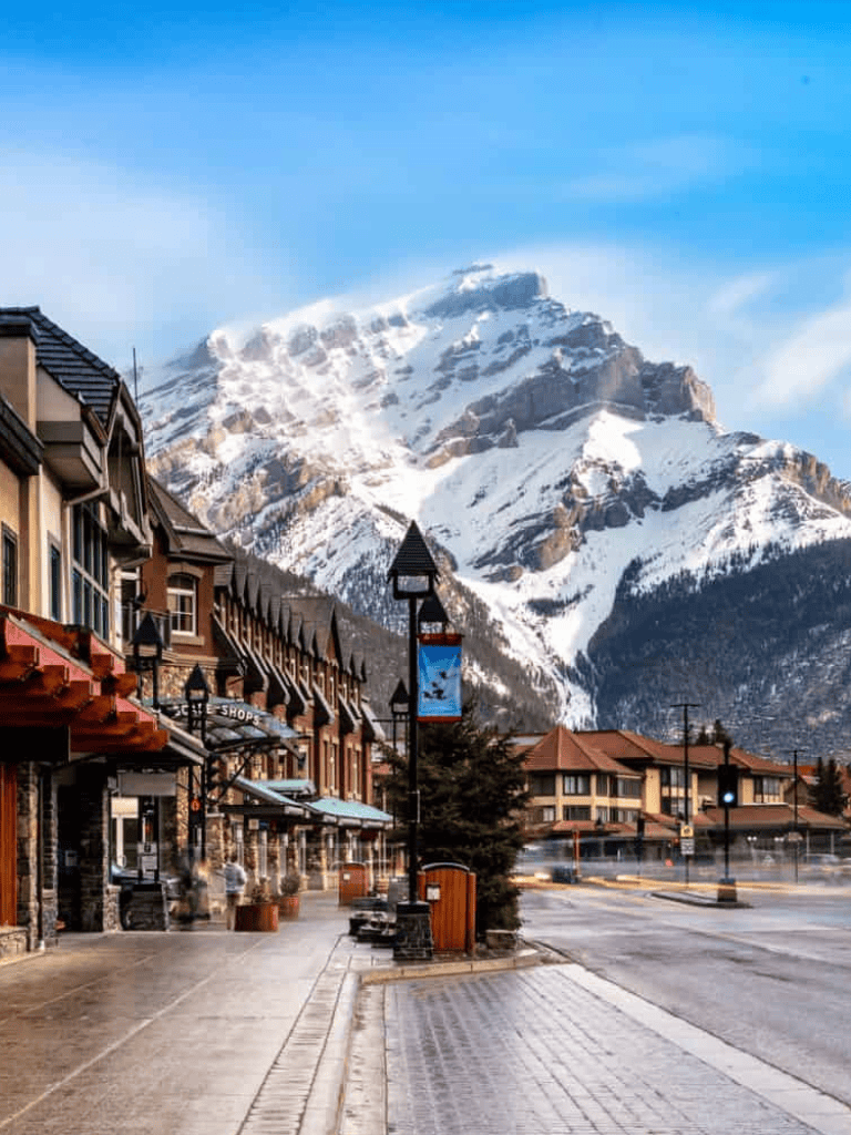 Snow-capped mountain and charming town street in Whistler during winter morning.