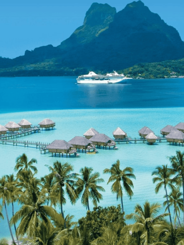 Luxurious overwater bungalows with tropical palm trees in a stunning island paradise.