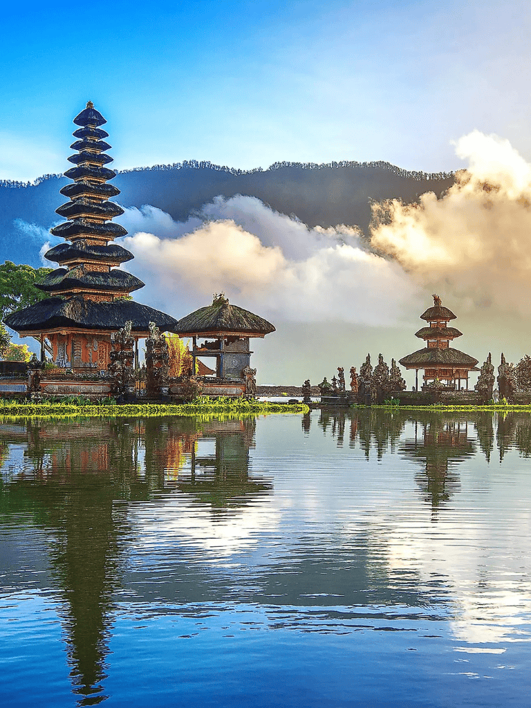 Serene temple reflection on water at sunset, Bali Indonesia, popular travel destination for spiritual tourism and scenic views.