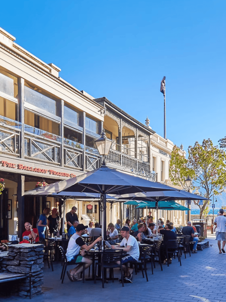 Alto text: Vibrant outdoor dining scene at Quest for Directions in a charming historic town.