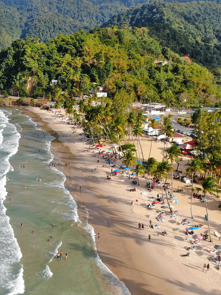Sunset Beach in Hawaii, lush greenery, sandy shoreline, palm trees, popular vacation destination.