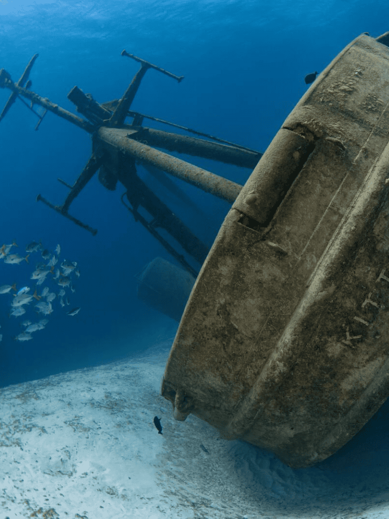 Wreckage of sunken helicopter on ocean floor, underwater exploration, maritime accident scene.