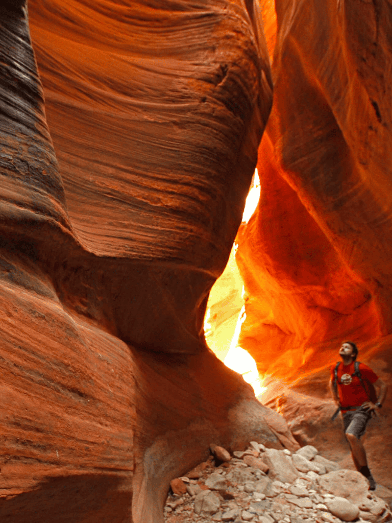 Vivid canyon hike through narrow slot canyon with colorful rock formations in Utah.