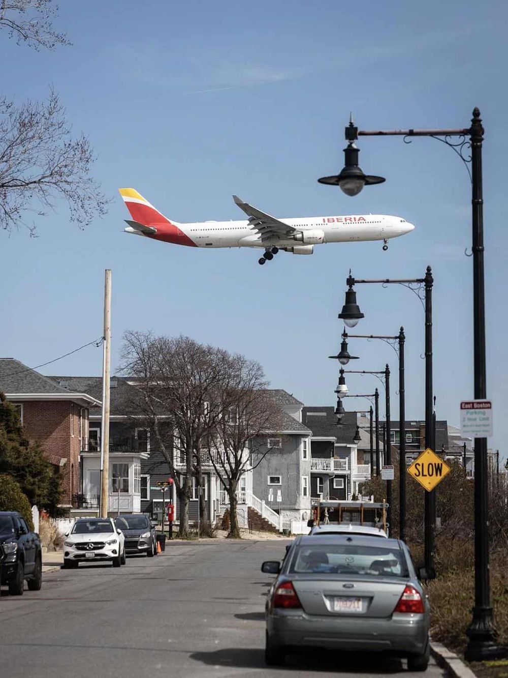 1. Airplane flying over residential neighborhood in Boston, Massachusetts.