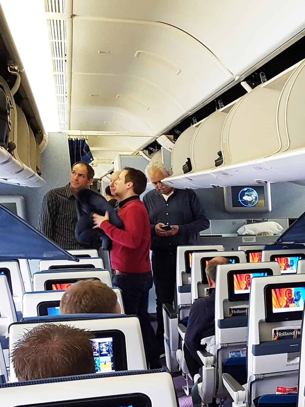 Passenger safety briefing on airplane, flight crew preparing passengers, in-flight safety instructions, healthcare safety.