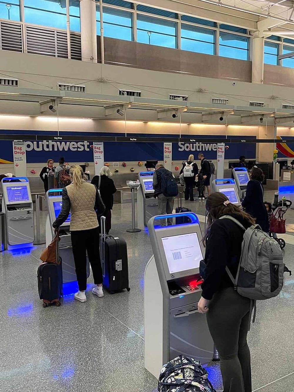 Self-service check-in kiosks at Southwest Airlines baggage claim area.