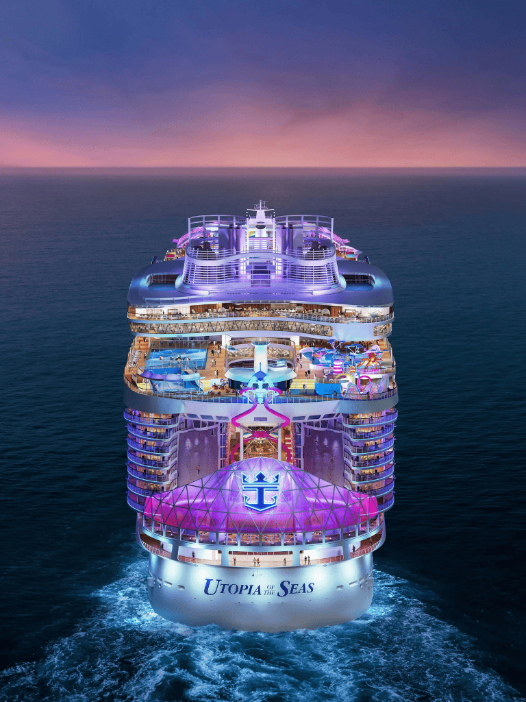 Luxurious cruise ship Utopia of the Seas sailing at sunset with vibrant lighting.