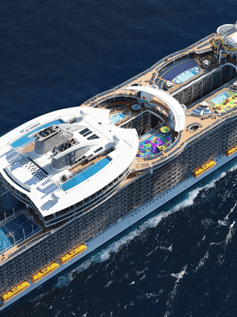 Luxurious cruise ship with water slides, pools, and entertainment on the ocean.