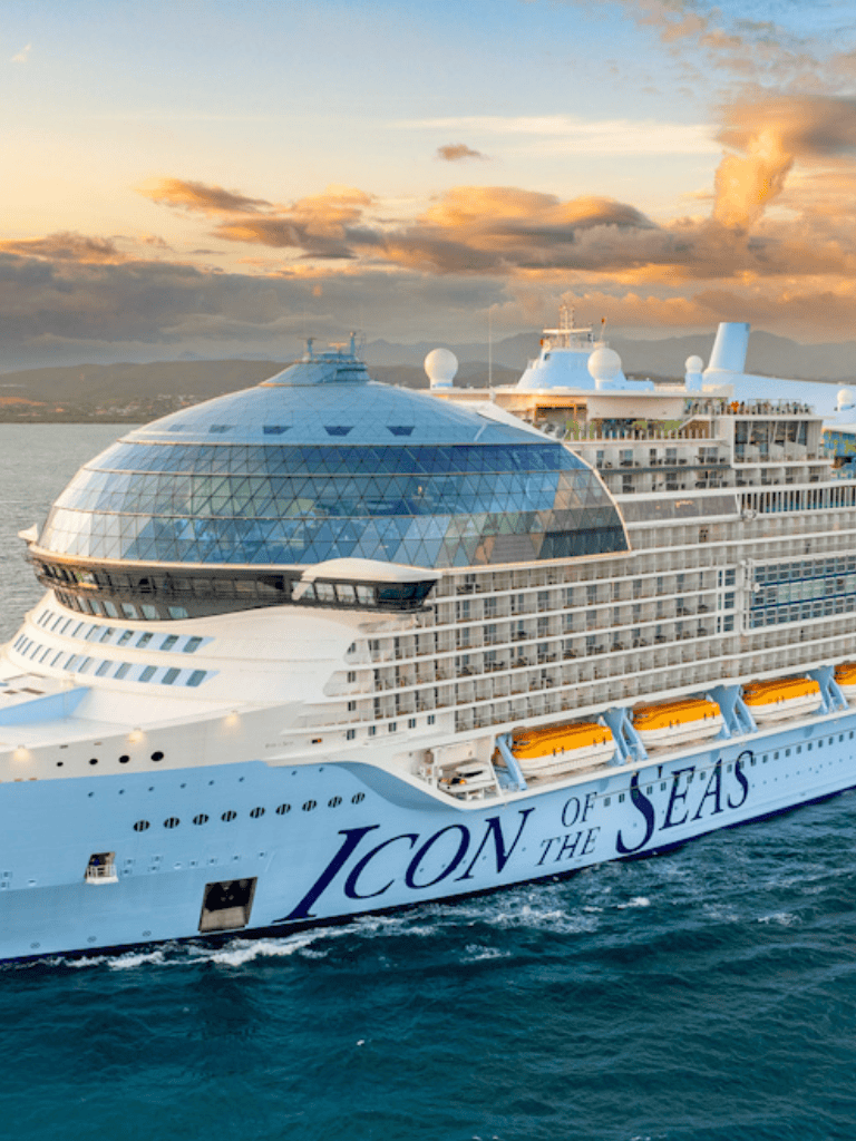 Luxury cruise ship ICON OF THE SEAS sailing at sunset, world's largest cruise vessel, perfect for luxury vacations.