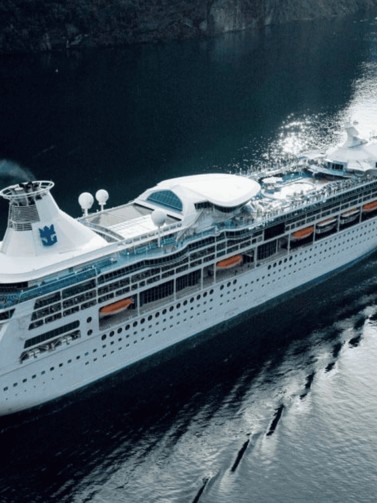 Luxury cruise ship sailing on the ocean, vessel with multiple decks and amenities, travel and vacation destination.