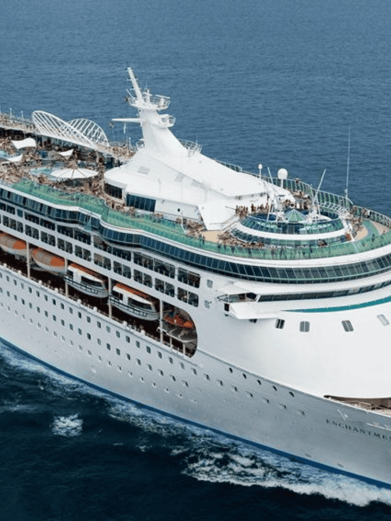 Luxurious cruise ship by the ocean with multiple decks and amenities, perfect for ocean travel.