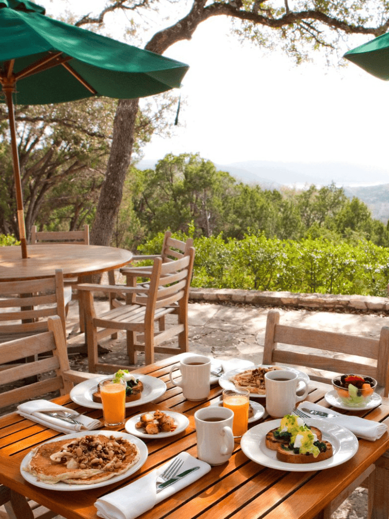 Alfresco breakfast with scenic mountain view and outdoor dining furniture.