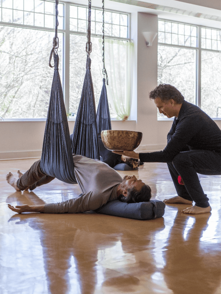 Yoga therapy session with assisted stretches in a serene studio environment.