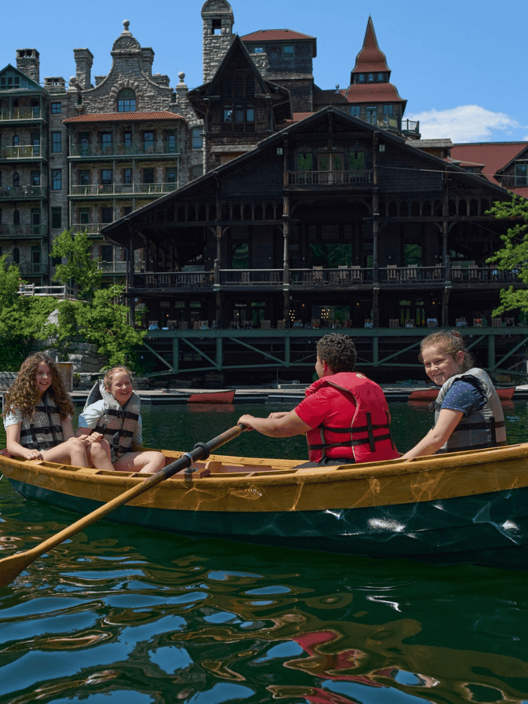 Quiet boat ride on a scenic riverfront with historic buildings in the background, perfect for outdoor adventure and family fun.