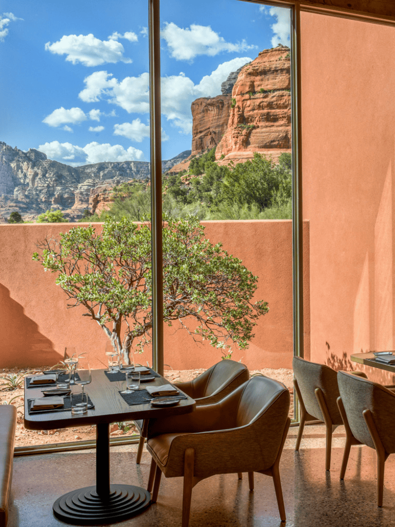 Desert view dining with scenic red rock mountains and modern interior.