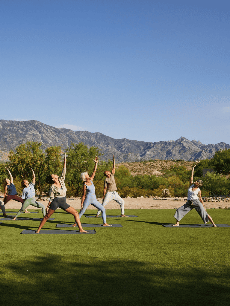 Sunrise yoga session outdoors with mountain backdrop for wellness and mindfulness.