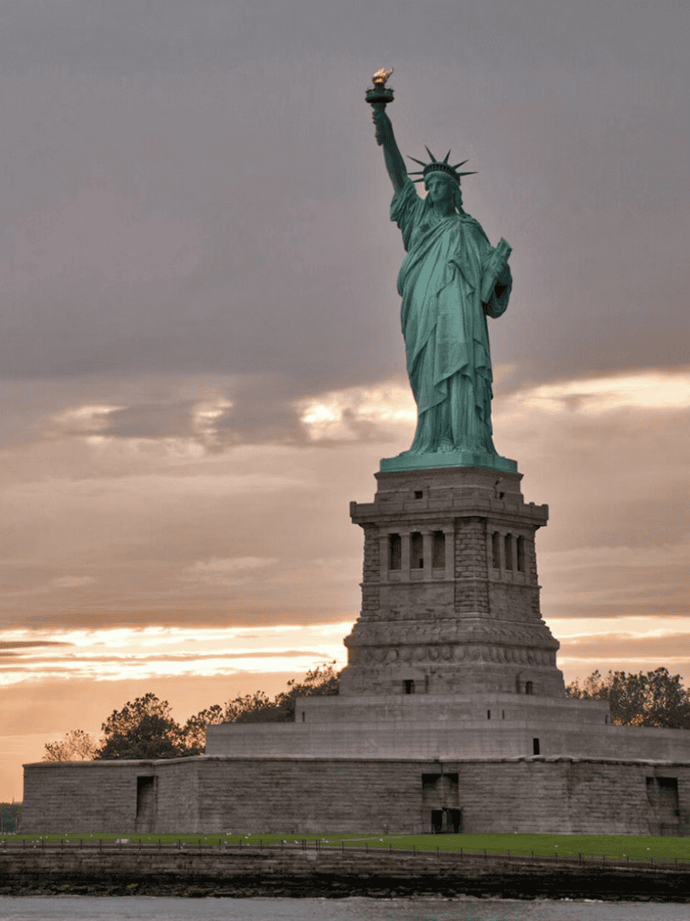 Ancient Statue of Liberty at sunset, symbolizing freedom and travel inspiration.