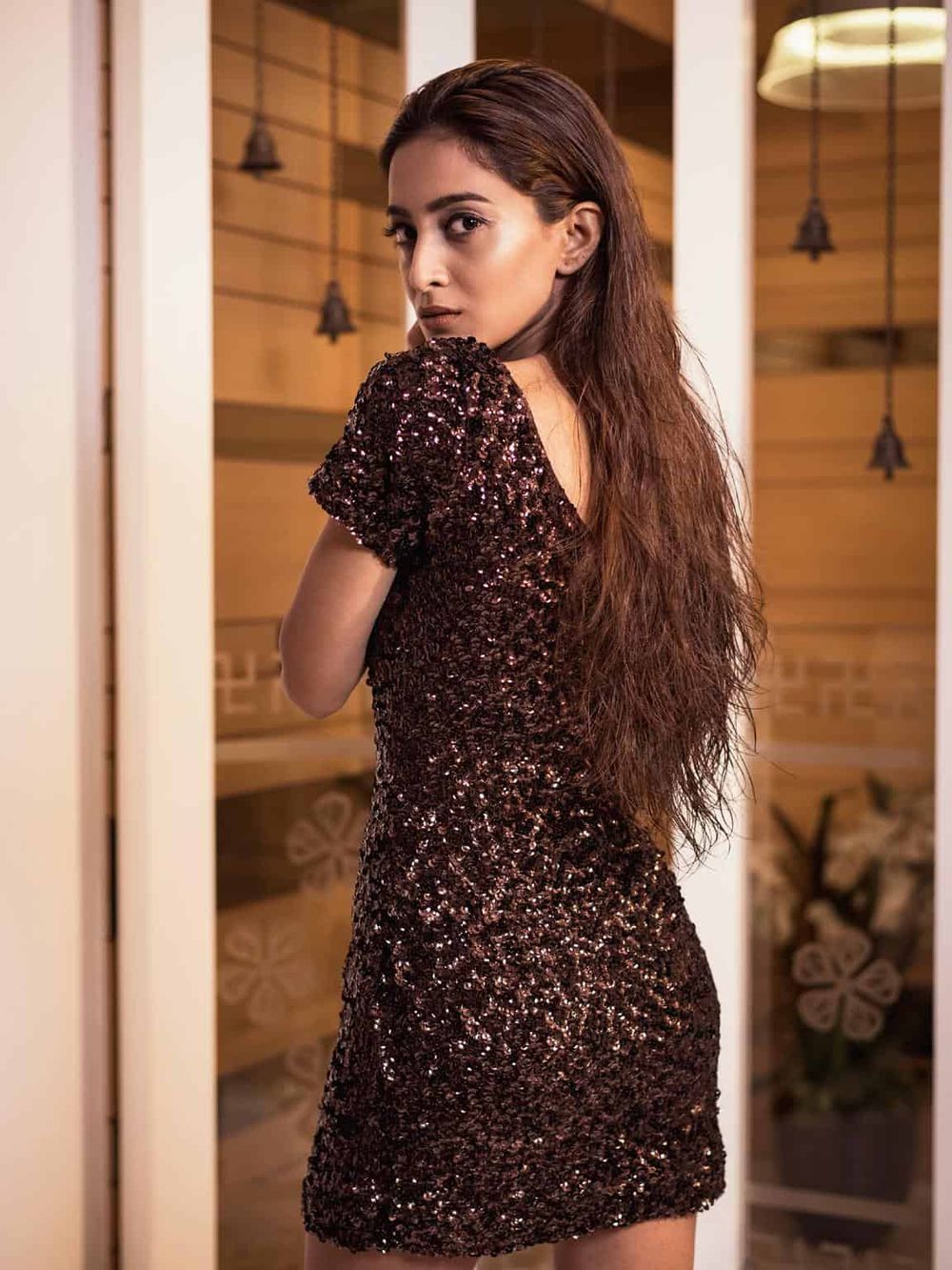 Stylish woman in a sparkly dress, representing fashion and elegance for quest for directions.