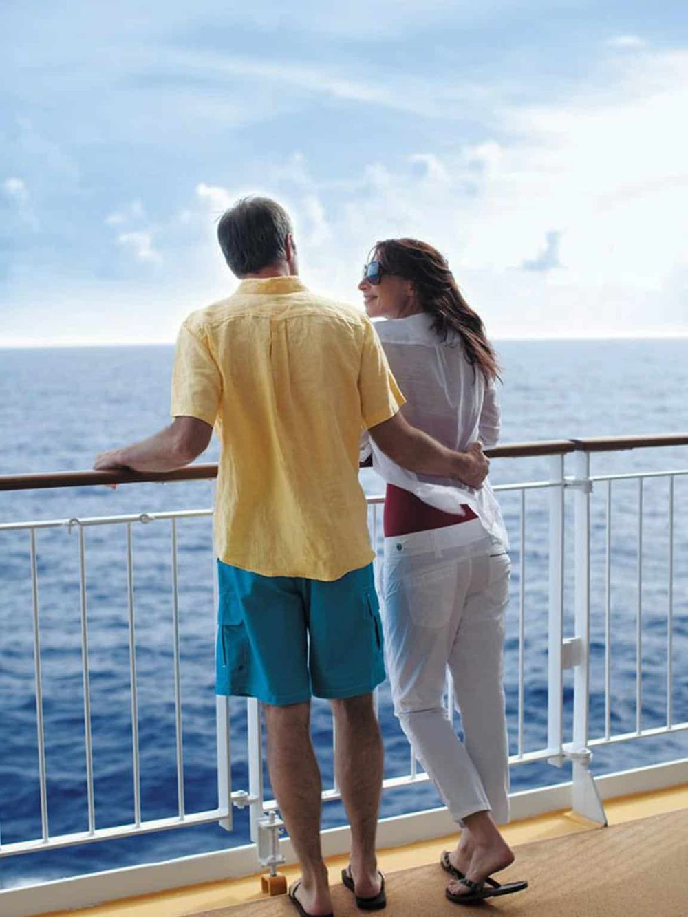 Relaxing vacation couple enjoying view on cruise ship deck, ocean scenery, travel adventure, cruise vacation, QuestForDirections.