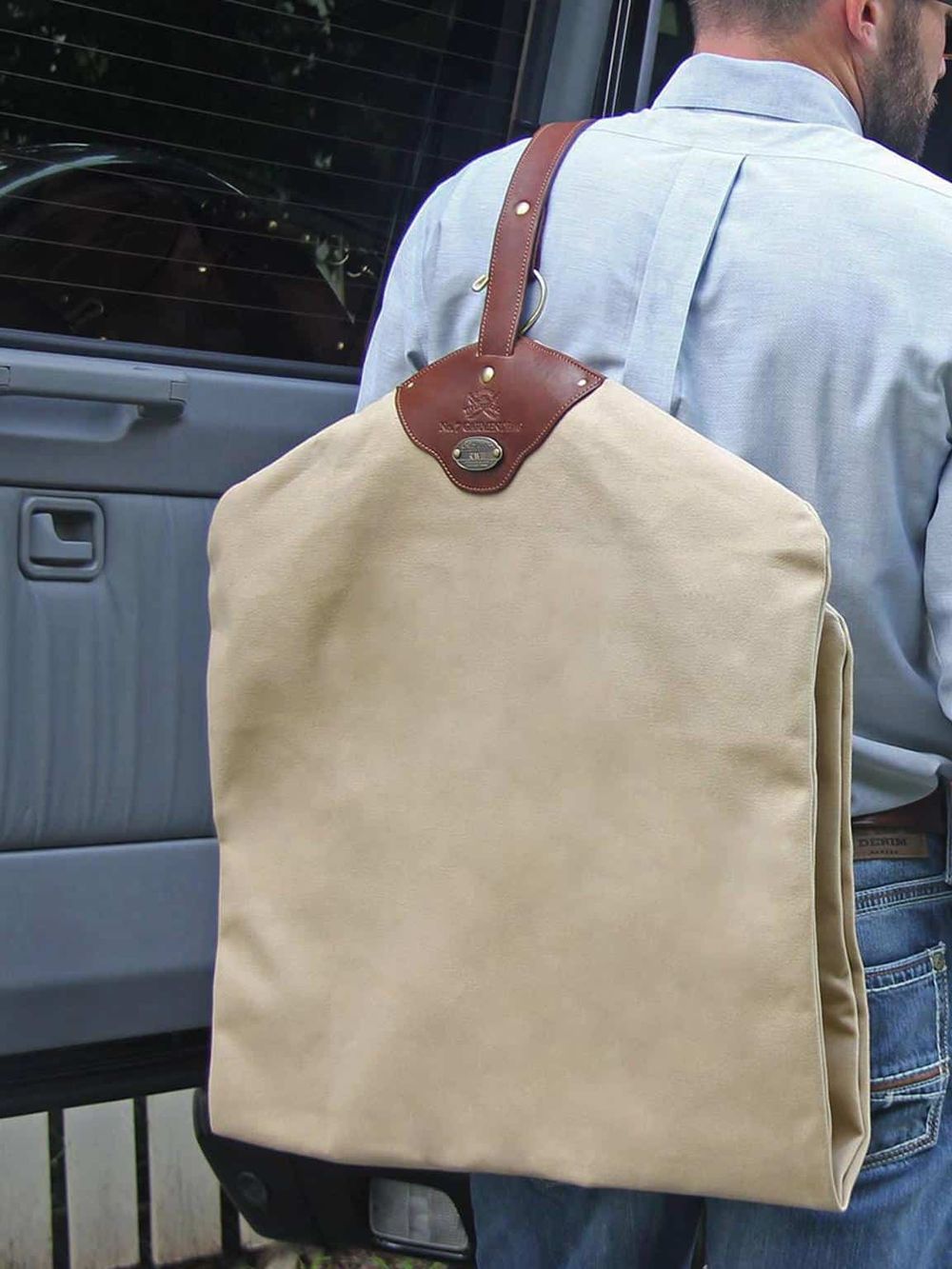 Stylish beige canvas and leather tote backpack for travel and everyday use for men.