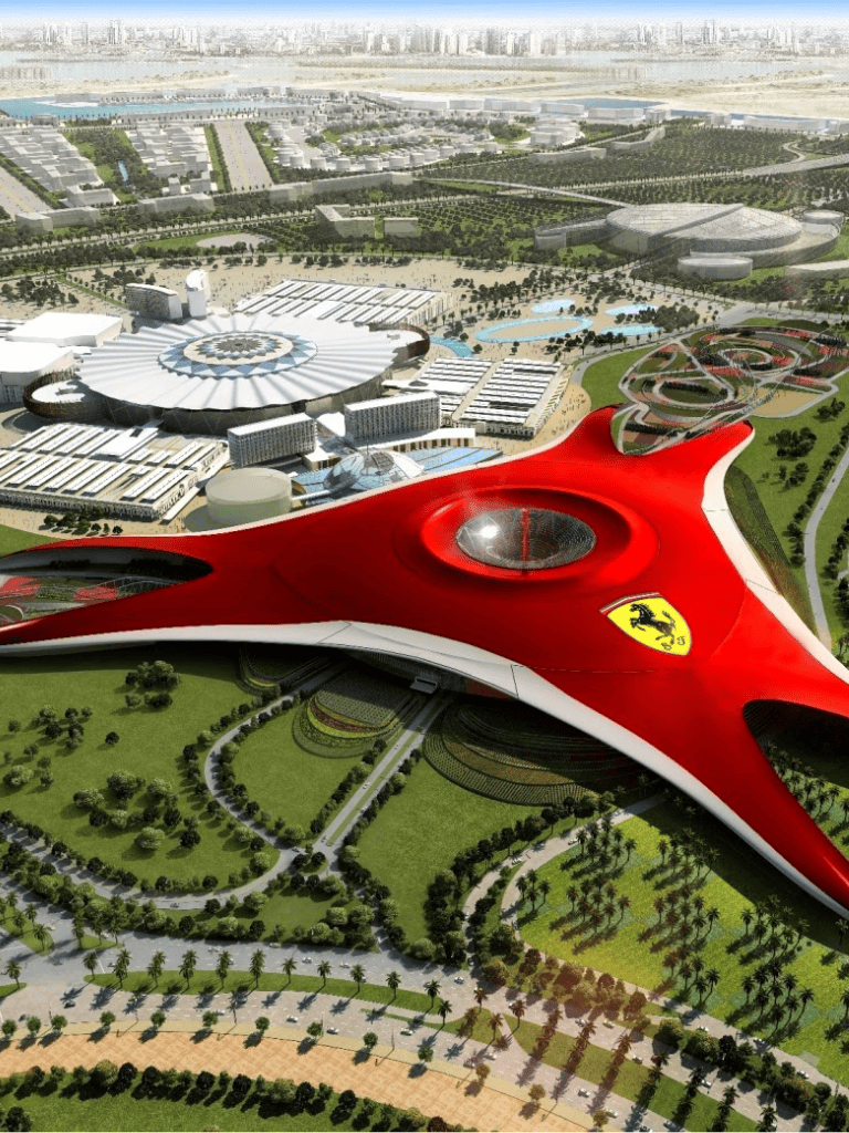 Futuristic Ferrari-themed building at Quest for Directions complex, Dubai skyline in background.