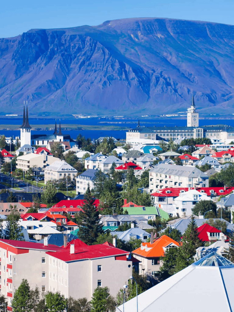 Colorful Icelandic town with mountains in the background.