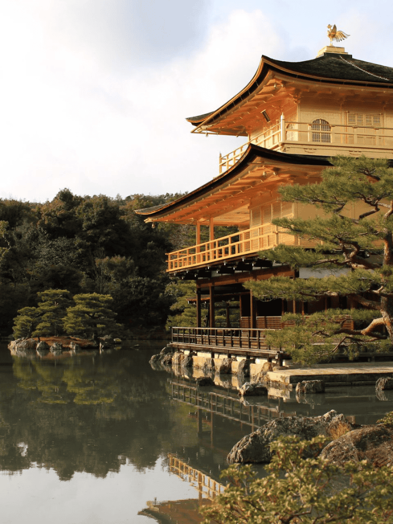 Traditional Japanese temple with pagoda architecture in a serene garden setting.