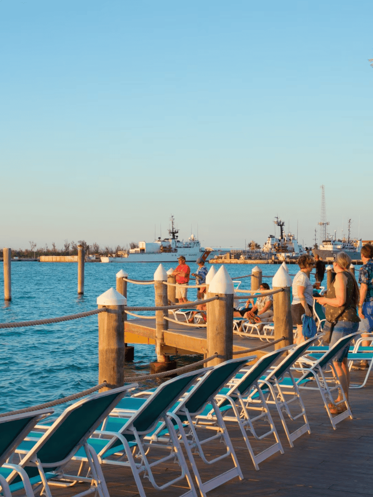 Relaxing dockside scene at QuestForDirections marina with boats, lounge chairs, and visitors enjoying the waterfront.