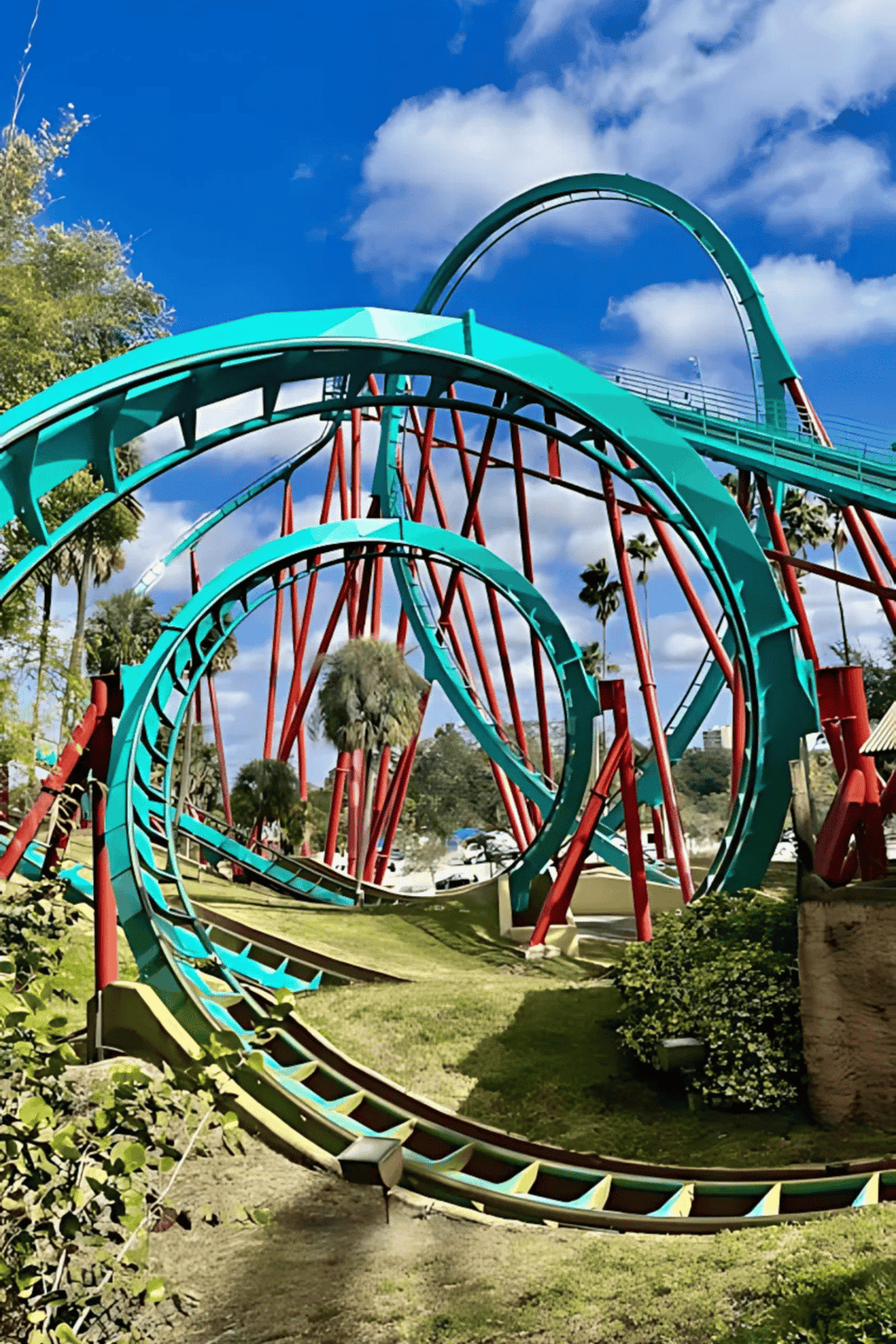 Thrilling roller coaster at Quest for Directions amusement park with bright blue sky backdrop.