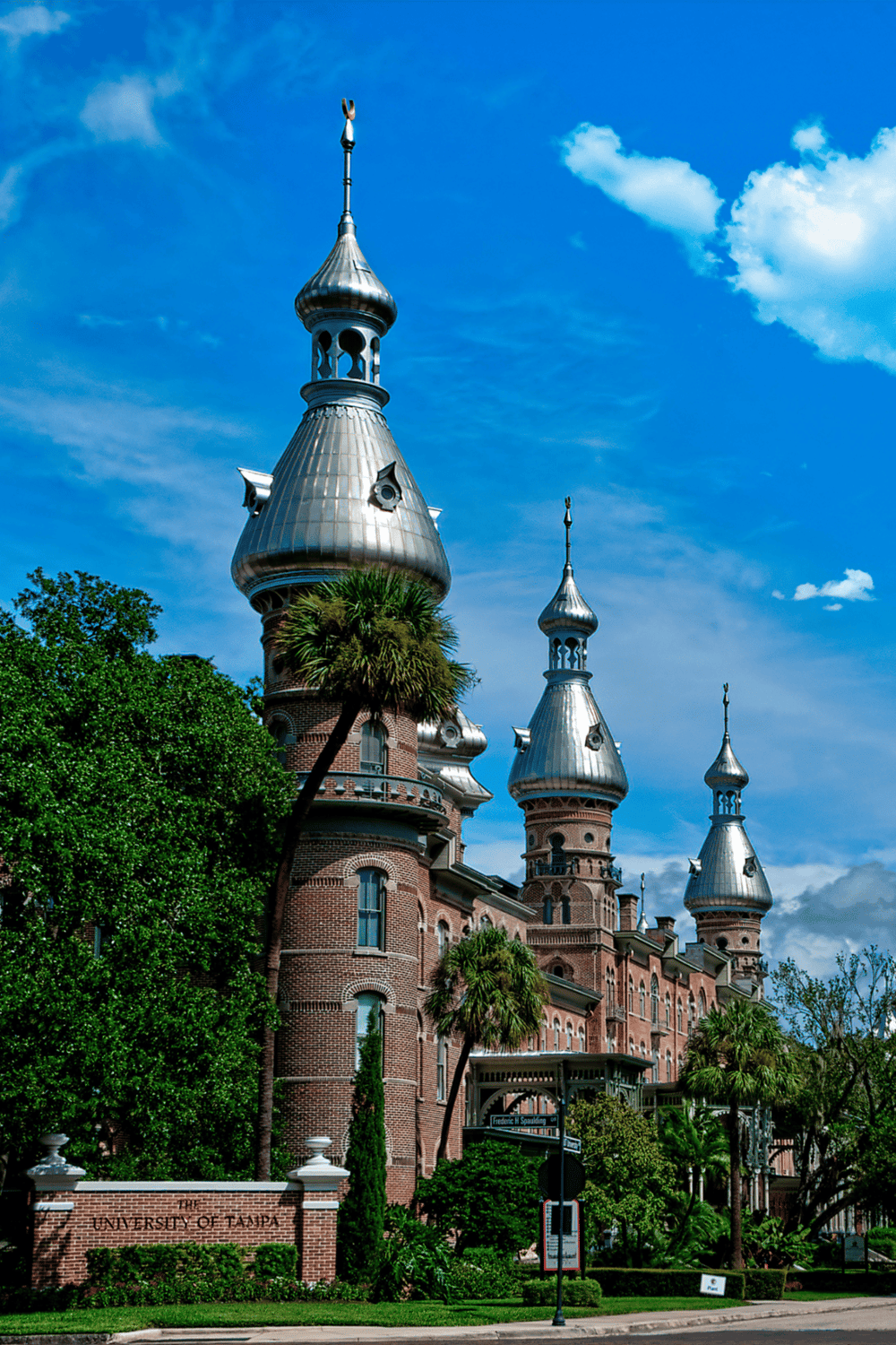 Colorful historic castle with ornate towers and lush green surroundings at the University of Tampa.