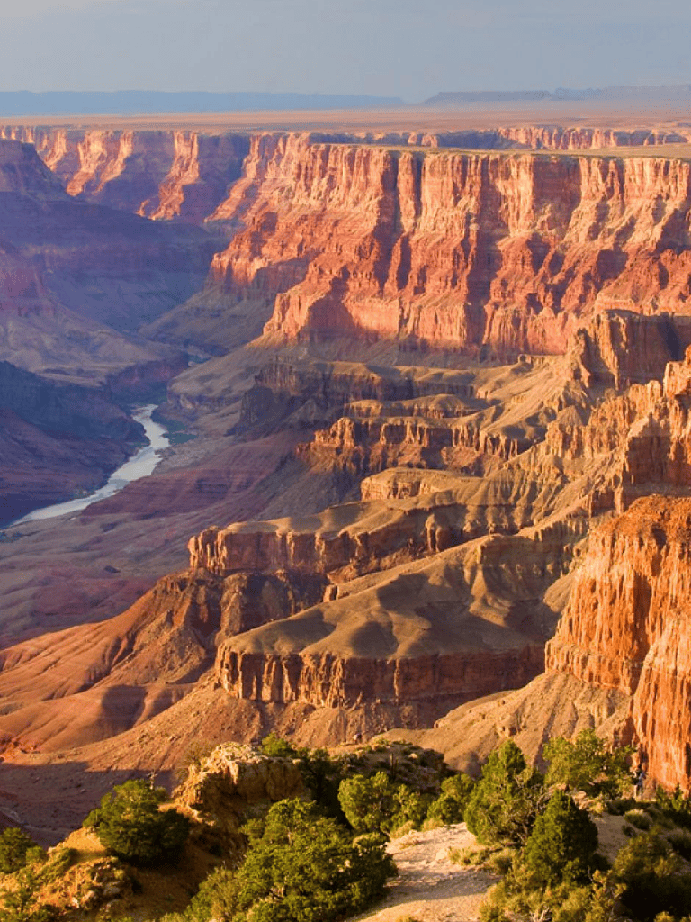 Breathtaking Grand Canyon landscape with red rock formations and Colorado River view, scenic Arizona national park.
