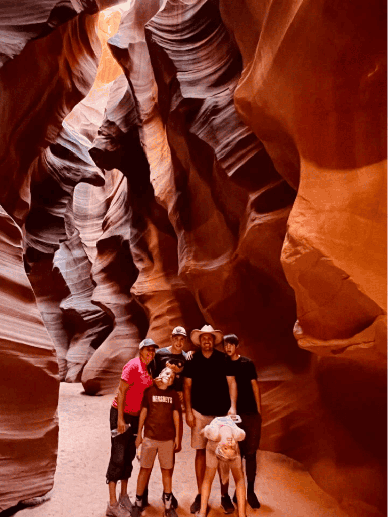 Colorful slot canyon hiking adventure with a group of people exploring the narrow rock formations.