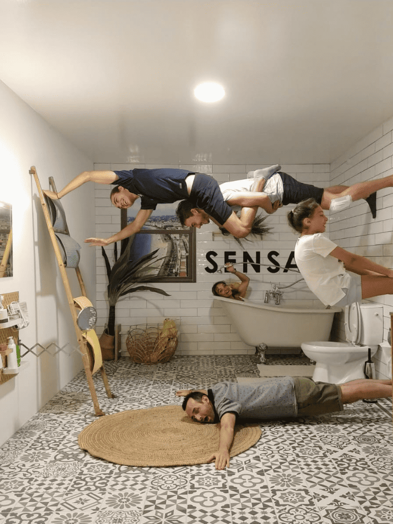 - Surreal bathroom scene with people floating and laying on the floor, creative art photo.