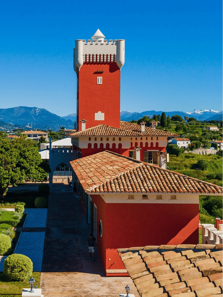 Colorful castle tower in a scenic mountainous landscape, perfect for travel and adventure enthusiasts.