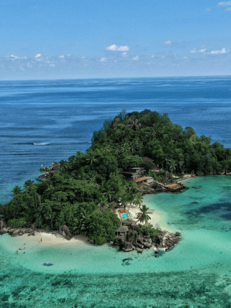 Serene tropical island with lush greenery and pristine beaches, perfect for relaxing and exploring.