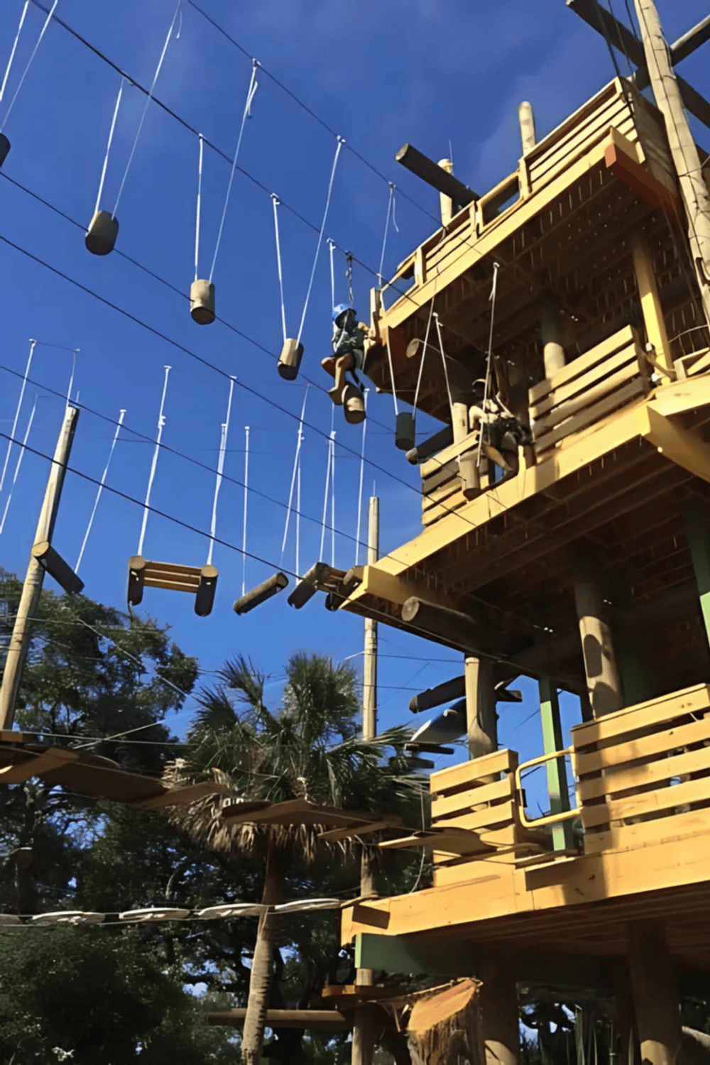 Climbing adventure at QuestForDirections zipline treehouse course, outdoor obstacle challenge, excitement, fun, and adventure.