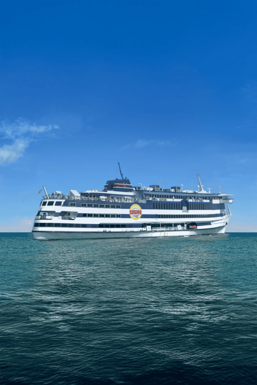 Cruise ship sailing on open water under clear blue sky, popular vacation and travel destination.