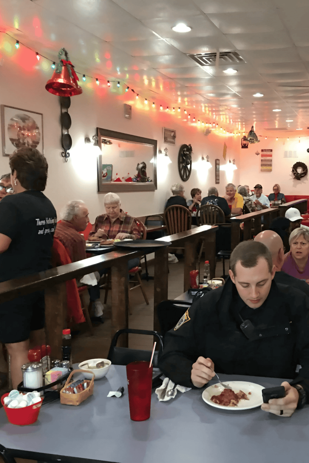 1. Festive restaurant interior with holiday decorations and group dining atmosphere.