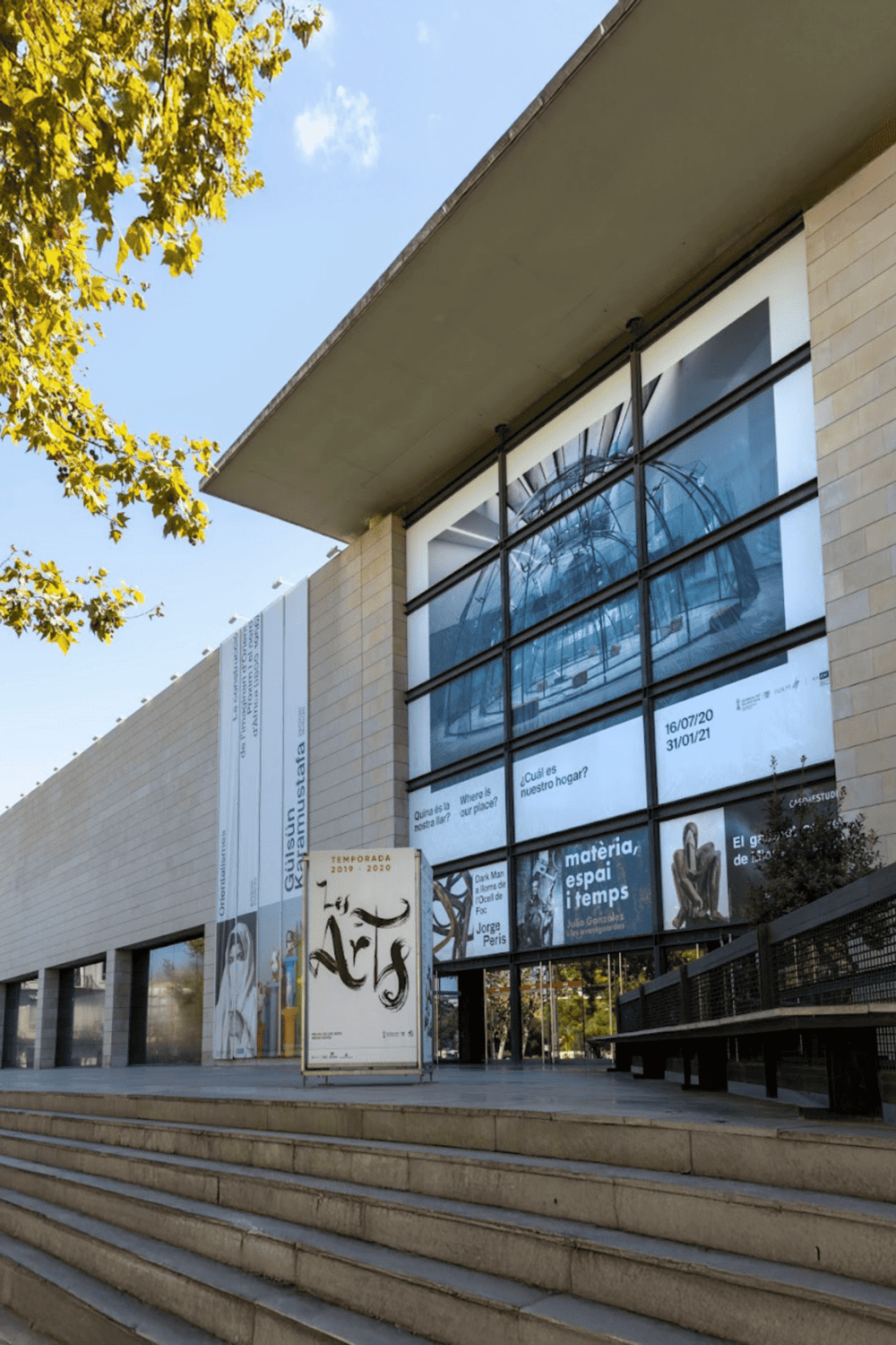 Modern museum building with large glass windows and art displays at QuestForDirections headquarters.